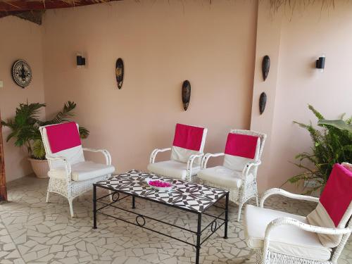 a group of chairs and a table on a patio at Mandinka Lodge in Kololi