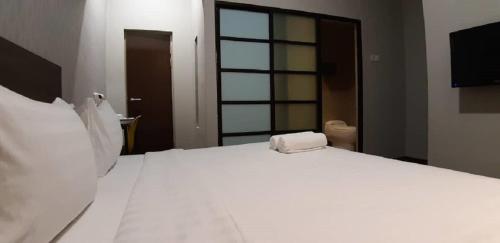 Ένα ή περισσότερα κρεβάτια σε δωμάτιο στο MIICO Hotel @ Mount Austin