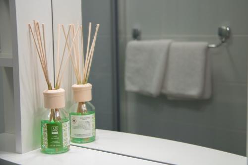 two bottles on a bathroom counter in front of a mirror at Ninas Apartments in Mostar