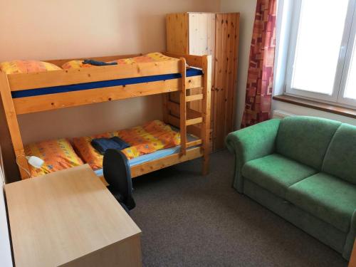 a room with two bunk beds and a couch at Ferienhaus Hlidek in Nová Lhota