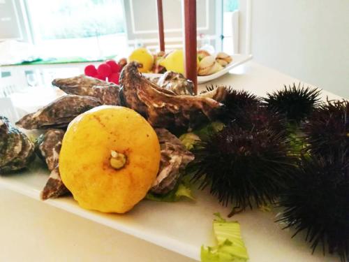 a plate of food on a counter with vegetables at Regiohotel Manfredi in Manfredonia