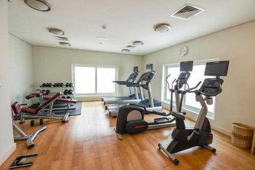 a gym with treadmills and elliptical machines at Premier Inn Dubai International Airport in Dubai