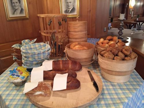a table topped with different types of bread and potatoes at Romantik Hotel Säntis in Appenzell