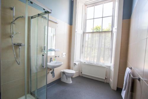 a bathroom with a shower and a toilet and a sink at Trinity College - Campus Accommodation in Dublin