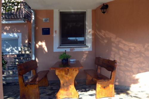 a wooden table and two chairs in front of a building at Apartment Akaju in Rovinjsko Selo