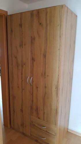 a wooden cabinet with silver handles in a room at Ferienwohnung Zauberhaft in Bad Soden-Salmünster