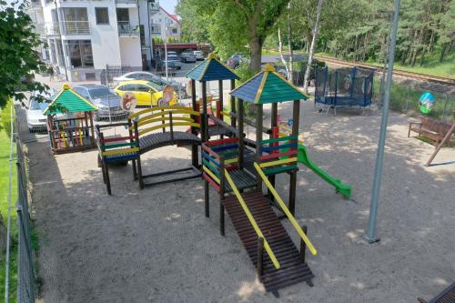 a group of playground equipment in a park at Hotel 77 Restauracja Spa in Chałupy