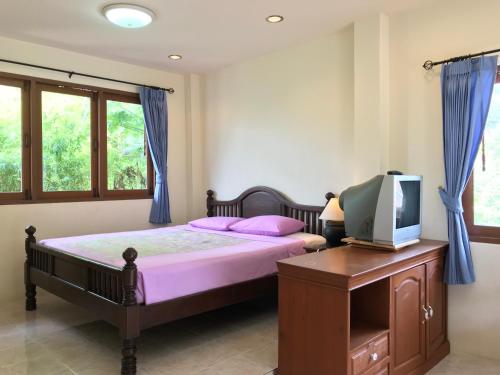 Ένα ή περισσότερα κρεβάτια σε δωμάτιο στο Sunrise Bungalow