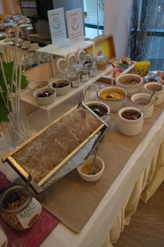 a table topped with lots of different types of food at Hotel Ivano in Rimini