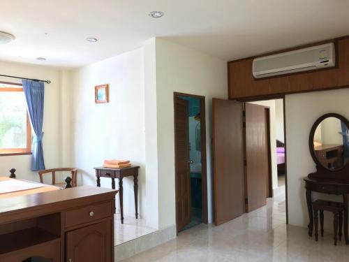 a bathroom with a sink and a mirror at Sunrise Bungalow in Lamai