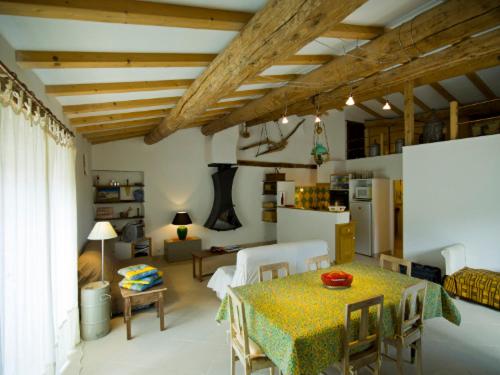 a living room with a table and a kitchen at Le Jas de Verdolier in Sault-de-Vaucluse