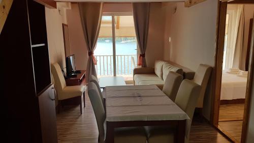 a small living room with a table and a couch at Apartments Angelo in Polače