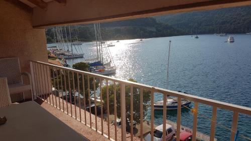 a balcony with a view of a marina with boats at Apartments Angelo in Polače
