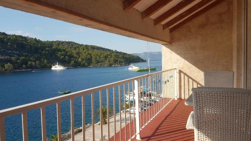 a balcony of a house with a view of the water at Apartments Angelo in Polače