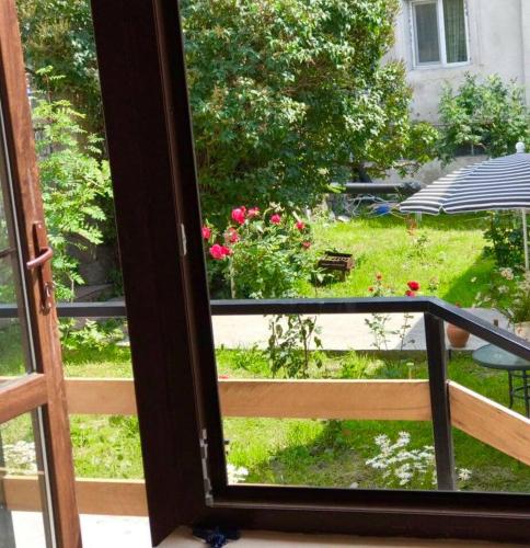 a view of a garden from a window at Soso Burduli's Guesthouse in Stepantsminda