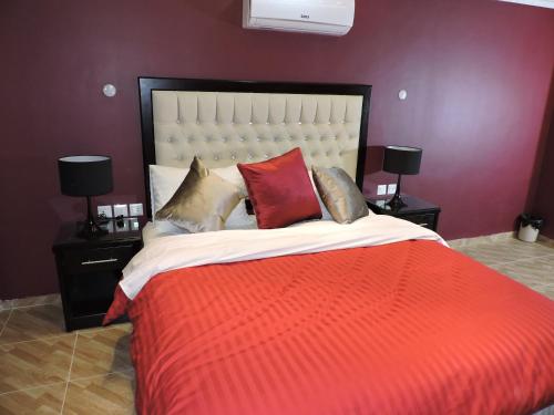 a bedroom with a large bed with a red blanket at Valentine Inn Luxury in Wadi Musa