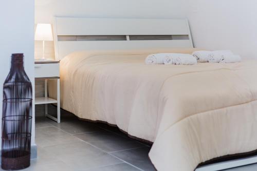 a bedroom with a bed with two pillows on it at Calasetta Residence in Calasetta