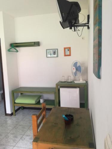 a dining room with a wooden table and a desk at Aldeia Jerome in Paul