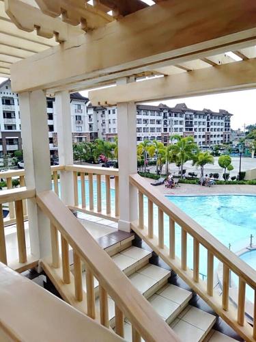 a balcony with a view of a pool and buildings at Alles One Oasis Condo Davao Near SM Mall with Wifi in Davao City