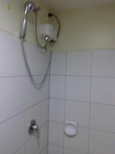 a shower with a shower head in a bathroom at Nica's Place Property Management Services at Horizons 101 Condominium in Cebu City