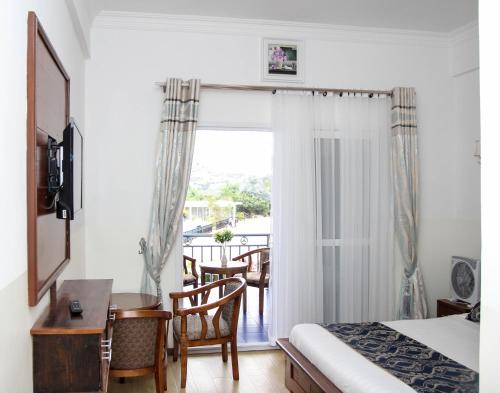 Ένα ή περισσότερα κρεβάτια σε δωμάτιο στο Hôtel Sky blue Mada