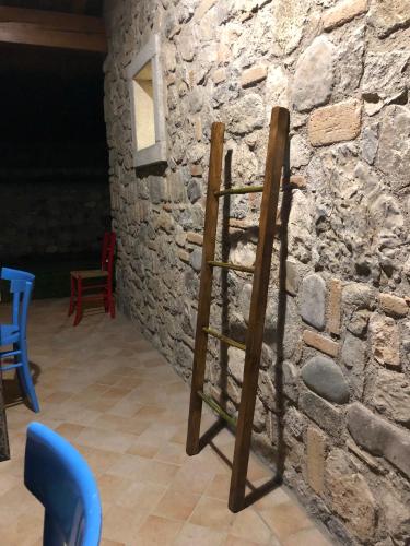 a wooden ladder leaning against a stone wall at Alla Vecchia Contrada B&B in Provaglio Val Sabbia