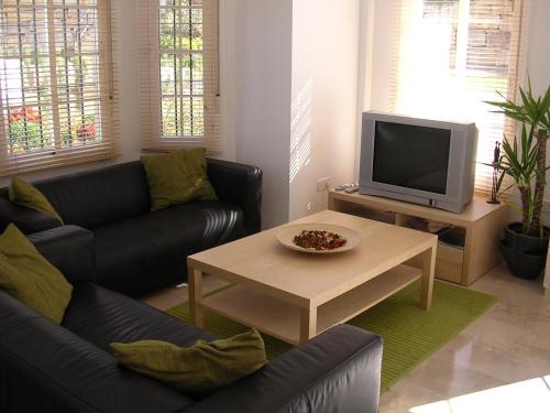 A television and/or entertainment centre at 3 Storey Townhouse - Costa Del Sol