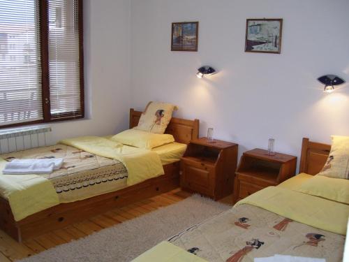 a bedroom with two beds and two night stands at Rahoff hotel in Bansko