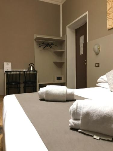 a bedroom with two white towels on a bed at Hotel Bogart Milano in Milan
