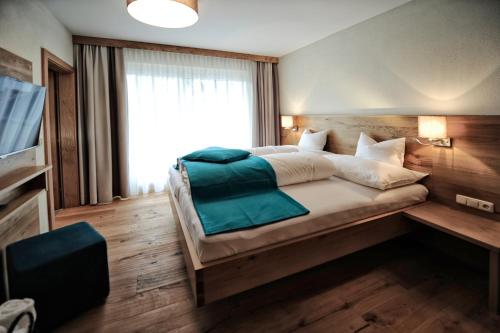 Uma cama ou camas num quarto em Hotel Dorfstadl