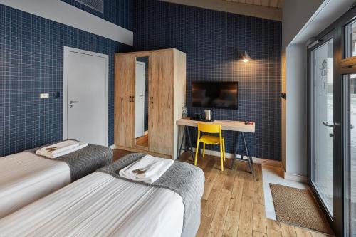 a hotel room with two beds and a desk at Salio Equisport Resort in Stryków