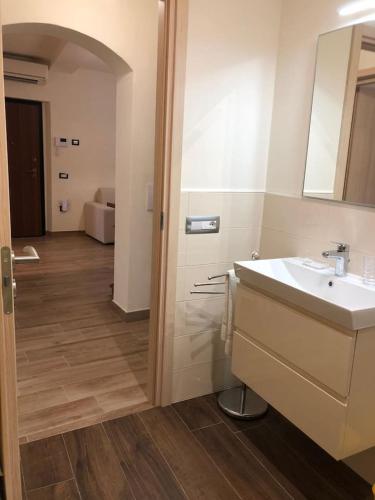 a bathroom with a sink and a mirror at Daniele Guest Apartment in Pistoia