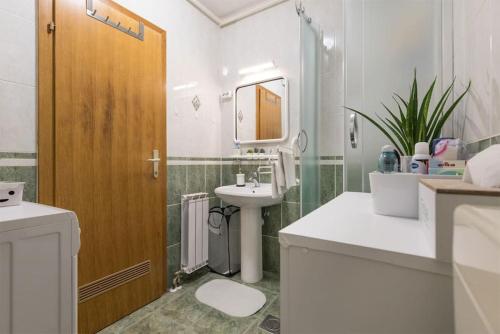 a bathroom with a sink and a toilet and a mirror at Studio apartman Comodo in Zagreb