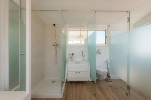 a bathroom with a sink and a glass shower at Casa Luisandra Boutique Hotel B&B in Luz