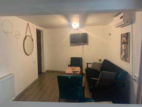 a living room with a couch and a tv at AIA Apartment in Kutaisi