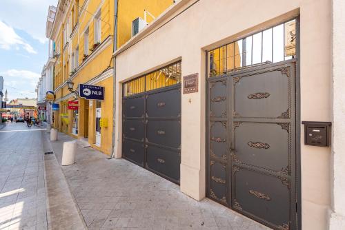 a street with two sets of doors on a building at Apartment Prince in Mostar
