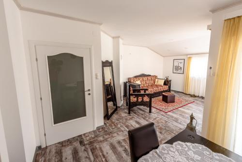 a living room with a couch and a chair at Apartment Prince in Mostar