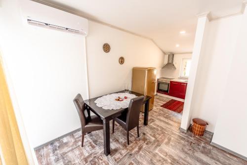a kitchen with a table and chairs in a room at Apartment Prince in Mostar