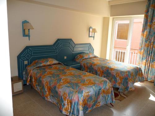 Postel nebo postele na pokoji v ubytování HOTEL KAMAL CITY CENTER