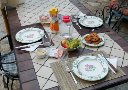 a table with plates and bowls of food on it at Casa Omnia B&B in Castellamonte
