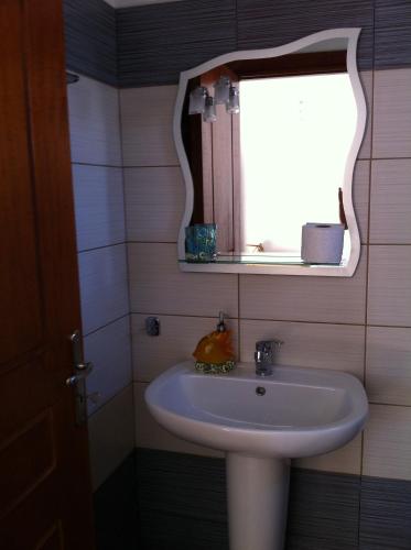 a bathroom with a sink and a mirror at Vythos in Adamas
