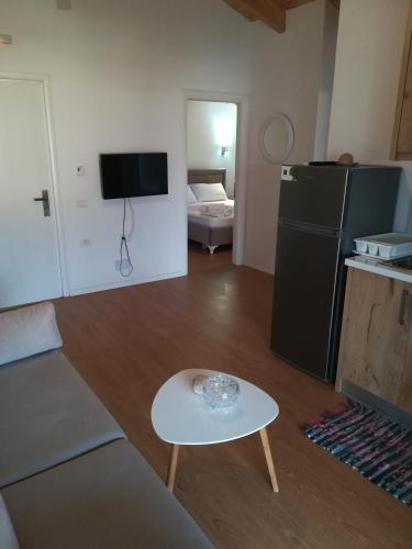 a living room with a couch and a table and a refrigerator at Villa Xani in Himare