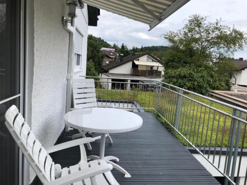 a balcony with a white table and two chairs at Sonnenhaus in Sindelfingen