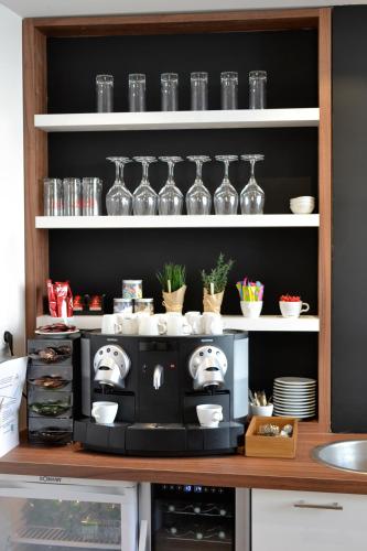 a kitchen with a microwave on a shelf at 5 Chambres en Ville in Clermont-Ferrand
