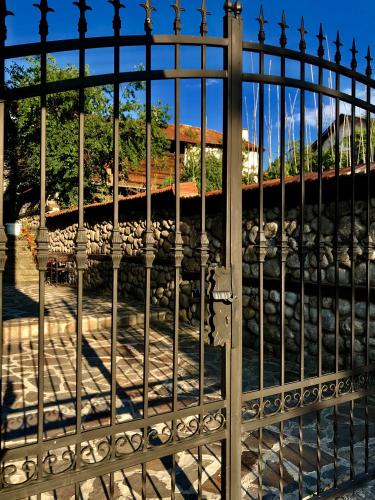 an iron gate with a view of a train track at Къща за гости Александра in Dobrinishte