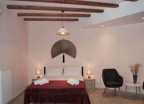 a bedroom with a bed and a chair and a table at Old Town Venetian Studio by CorfuEscapes in Corfu Town