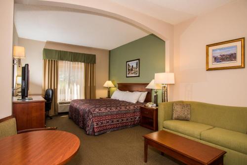 a hotel room with a bed and a couch at Round Hill Inn in Orange