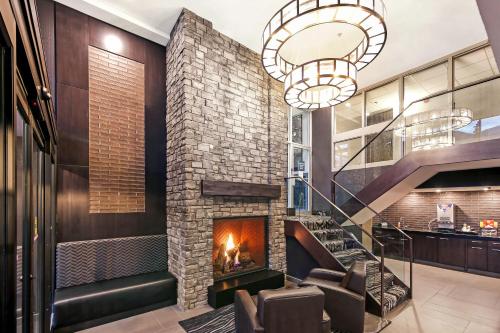 a fireplace in the lobby of a house at Best Western Plus Banff International Lodge in Banff