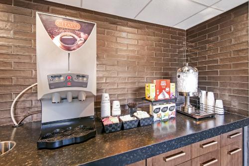 a kitchen with a coffee machine on a counter at Best Western Plus Banff International Lodge in Banff