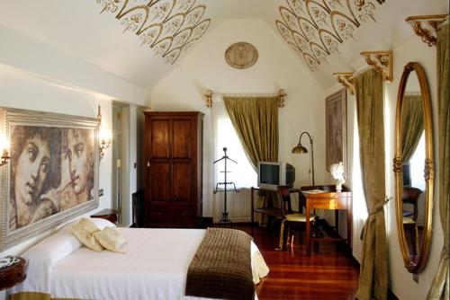 Postel nebo postele na pokoji v ubytování Hotel Palacete Peñalba